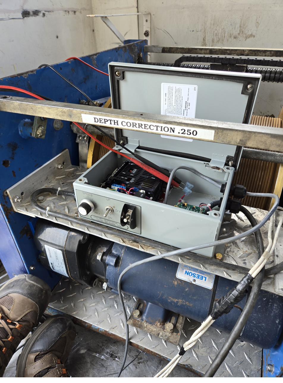 Depth correction control mounted on a logging winch